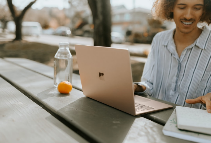Man working outside in the park on his laptop