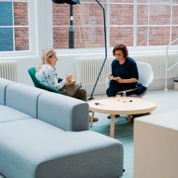 Two women sitting around a table brainstorming
