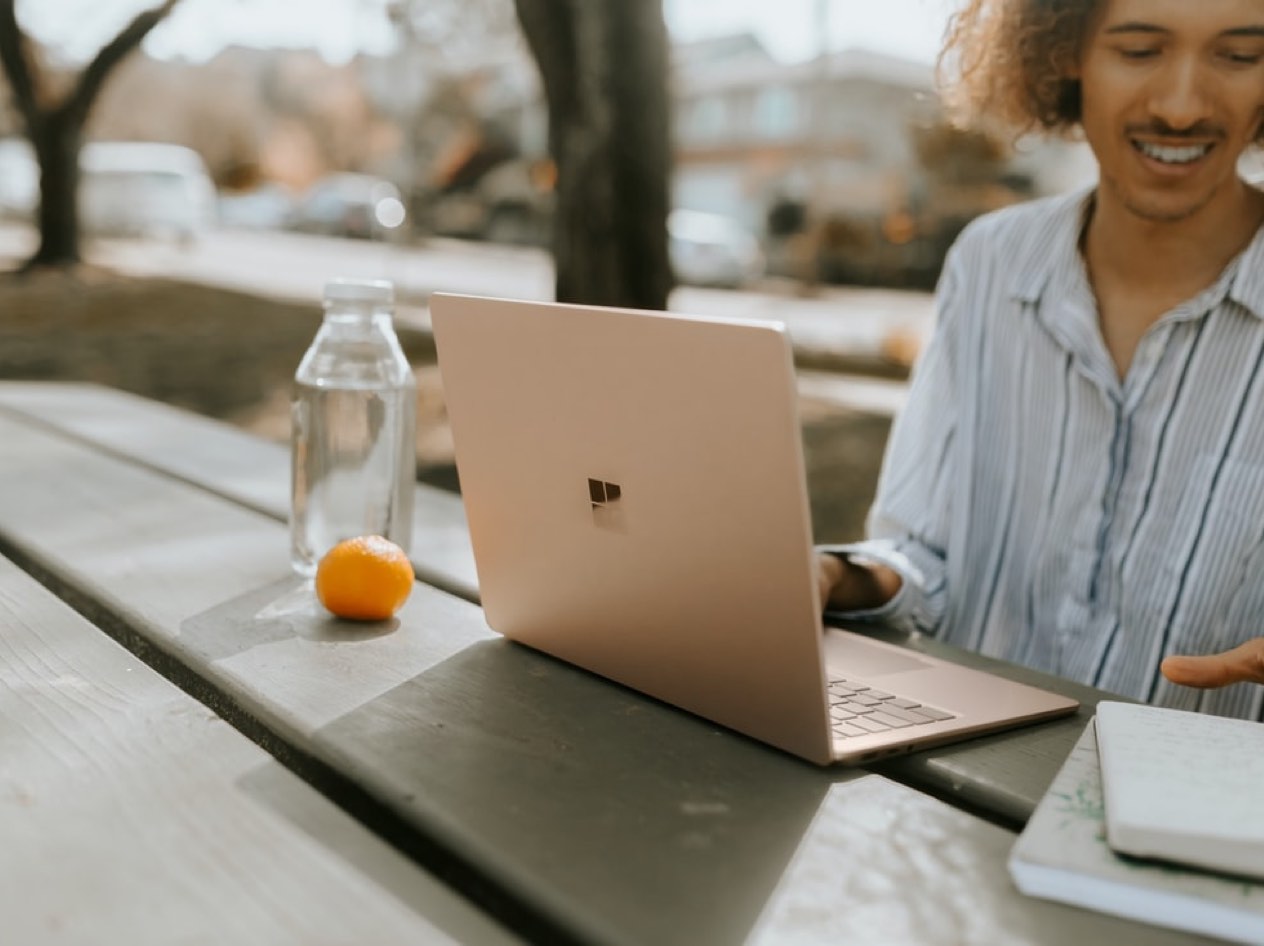 Man working outside in the park on his laptop