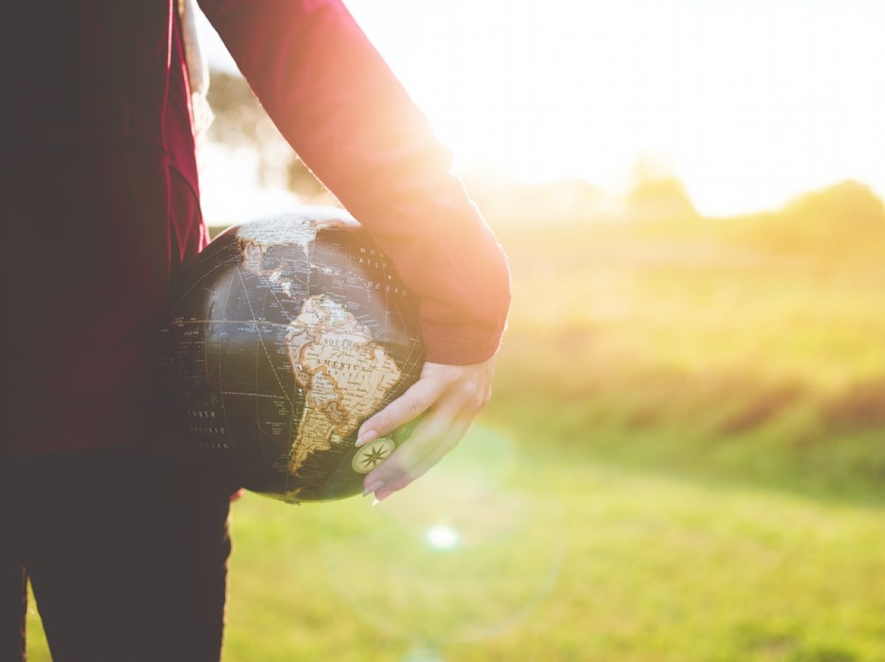 Close up of a woman holding a world globe in her hand